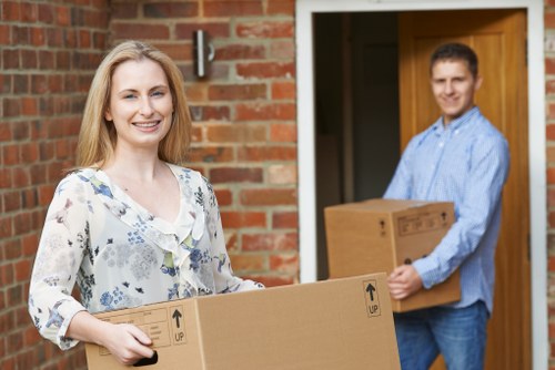 Removal crew handling desks and boxes in an East London office move