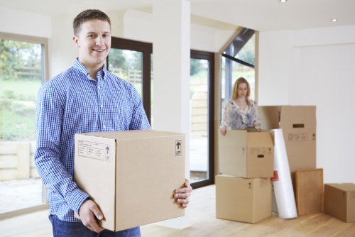 Local movers handling furniture in a Hackney street with tight access