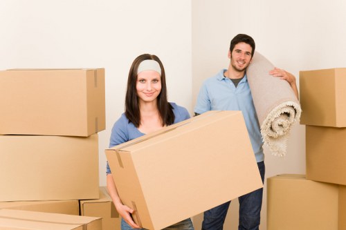 Professional movers handling a narrow staircase in a Hackney home