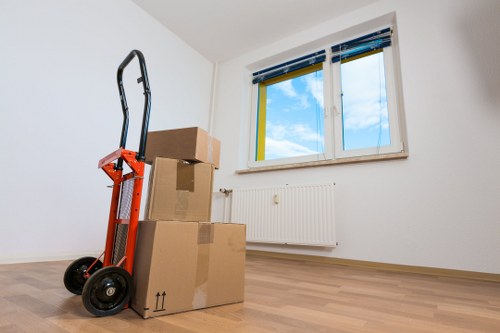 Local movers loading household boxes into a van in Hackney