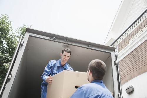 Team handling packed boxes and furniture with care