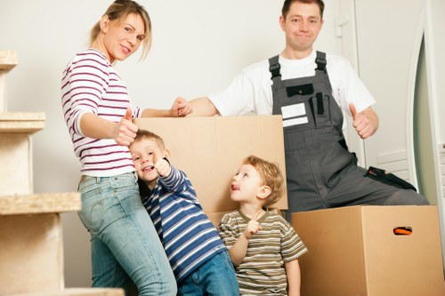 Packed moving boxes and furniture ready for transport in Hackney